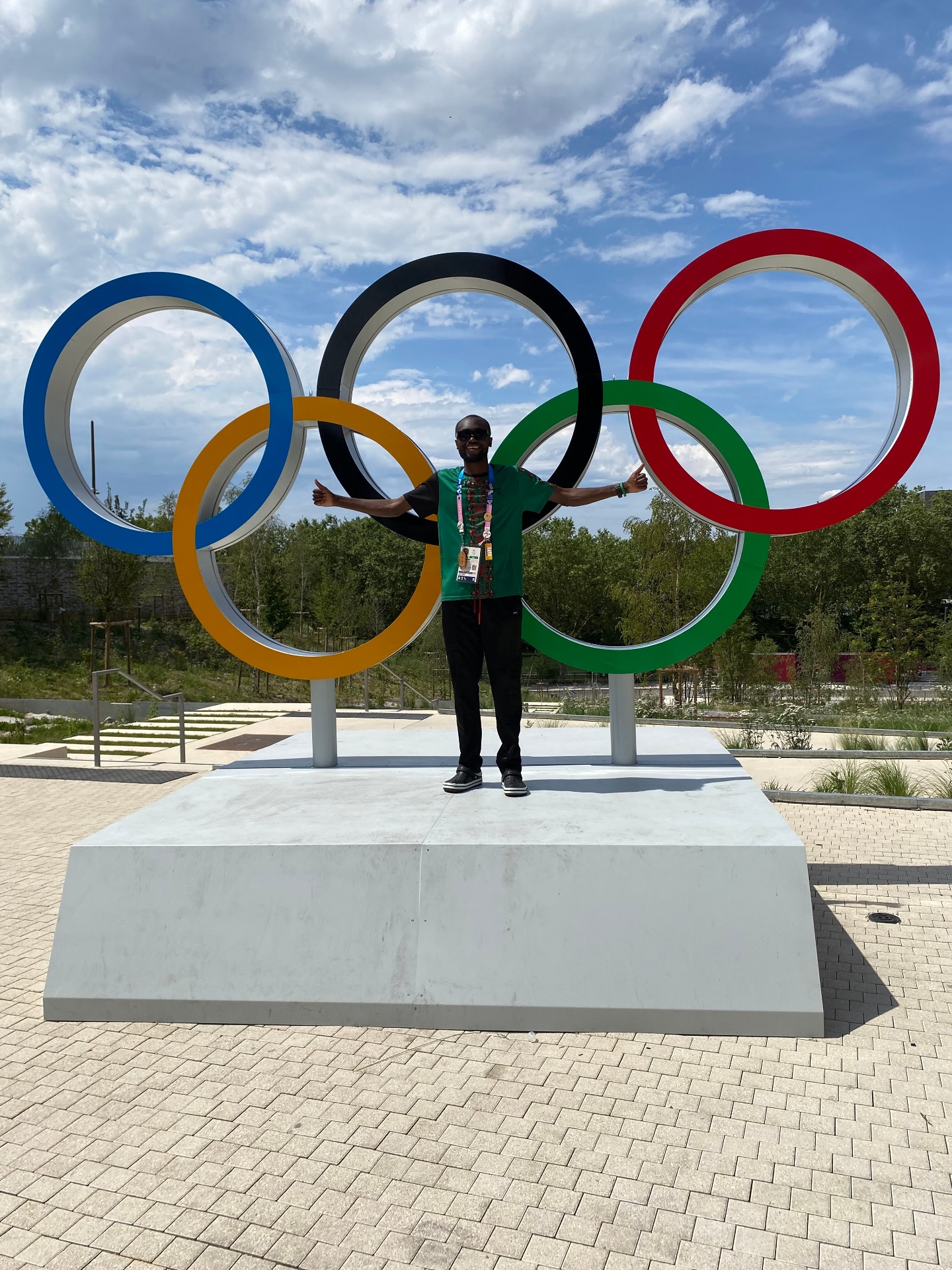 Felix Munyika at the Olympic Village with the Olympic Rings