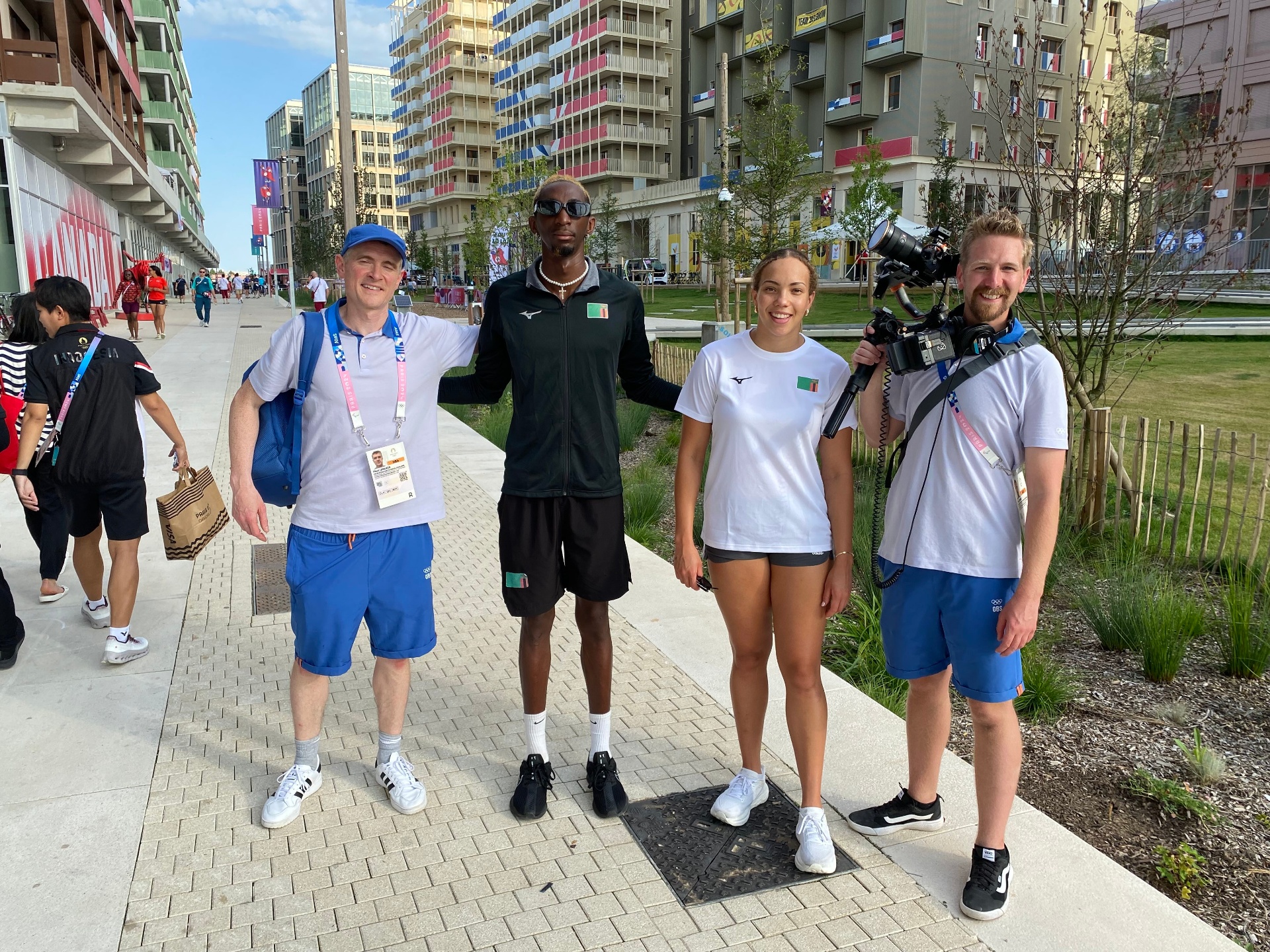 Swimmers Damien Shamambo and Mia Phiri with Olympic Broadcasting Services crew